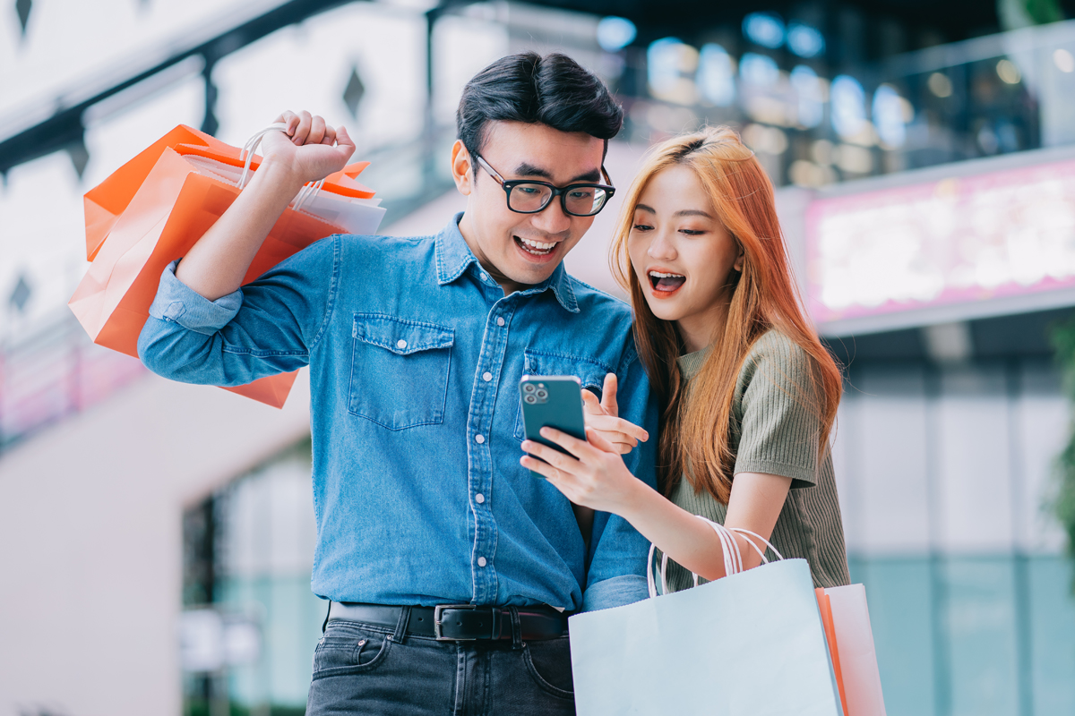 Asian couple using Buy Now Pay Later option for their shopping purchases.
